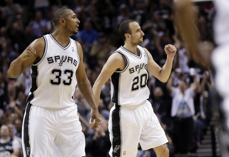 San Antonio Spurs' Boris Diaw (33), of France, and Manu Ginobili (20), of Argentina, celebrate during the first half of Game 1 of a Western Conference semifinal NBA basketball playoff series against the Portland Trail Blazers, Tuesday, May 6, 2014, in San Antonio. (AP Photo/Eric Gay)