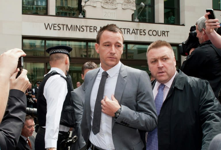 Chelsea footballer John Terry (C) leaves Westminster Magistrates court in London, on July 13, 2012 as he was found not guilty of racially abusing rival footballer Anton Ferdinand