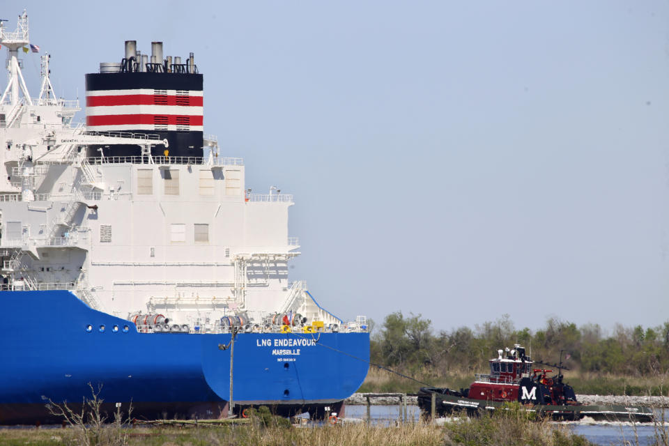 FILE - A tugboat helps guide a French ship, known as the LNG Endeavor, through Calcasieu Lake near Hackberry, La., on March 31, 2022. Russia’s war against Ukraine shattered its relations with Europe, which soon lost most of the natural gas that Moscow had long provided. Now, as winter nears, European nations have backed a short-term fix set to begin before the end of 2022 that has raised alarms among scientists who fear the long term consequences for the climate. (AP Photo/Martha Irvine, File)