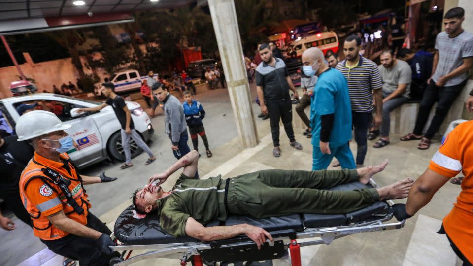 A Palestinian man injured in an Israeli airstrike is carried on a stretcher at Nasser Medical Hospital, in Khan Younis, Gaza on October 27, 2023. - Ahmad Hasaballah/Getty Images