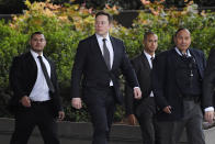 Tesla CEO Elon Musk, second from left, arrives at U.S. District Court Wednesday, Dec. 4, 2019, in Los Angeles. Musk is going on trial for his troublesome tweets in a case pitting the billionaire against a British diver he allegedly dubbed a pedophile. (AP Photo/Mark J. Terrill)