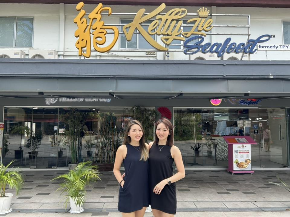 Zara Lim and Rachel Lim posing for a photo in front of their restaurant, Kelly Jie Seafood.