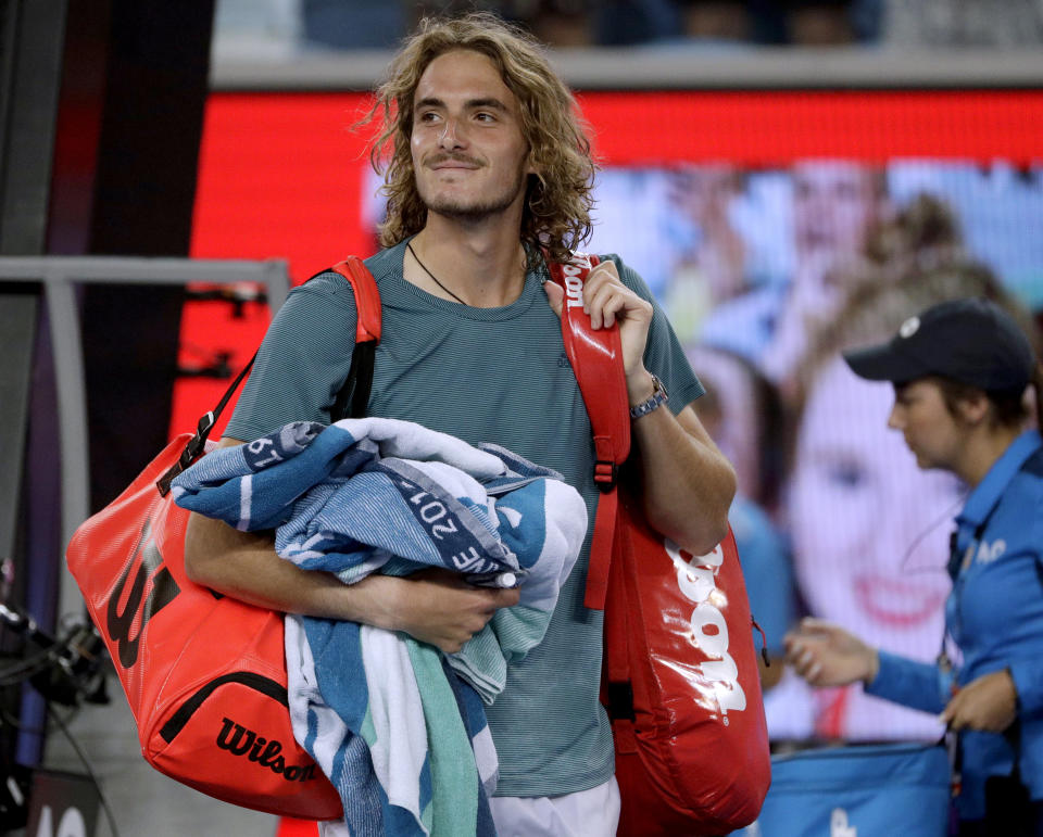 Greece's Stefanos Tsitsipas smiles as he leaves the court after defeating Georgia's Nikoloz Basilashvili during their third round match at the Australian Open tennis championships in Melbourne, Australia, Friday, Jan. 18, 2019. (AP Photo/Mark Schiefelbein)