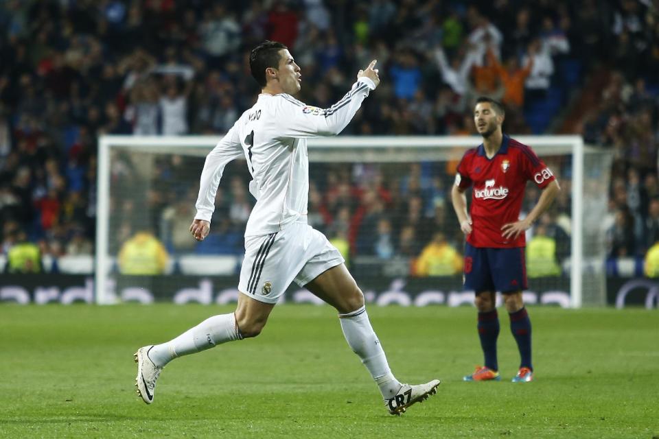 Real's Cristiano Ronaldo celebrates his second goal during a Spanish La Liga soccer match between Real Madrid and Osasuna at the Santiago Bernabeu stadium in Madrid, Spain, Saturday, April 26, 2014. (AP Photo/Andres Kudacki)