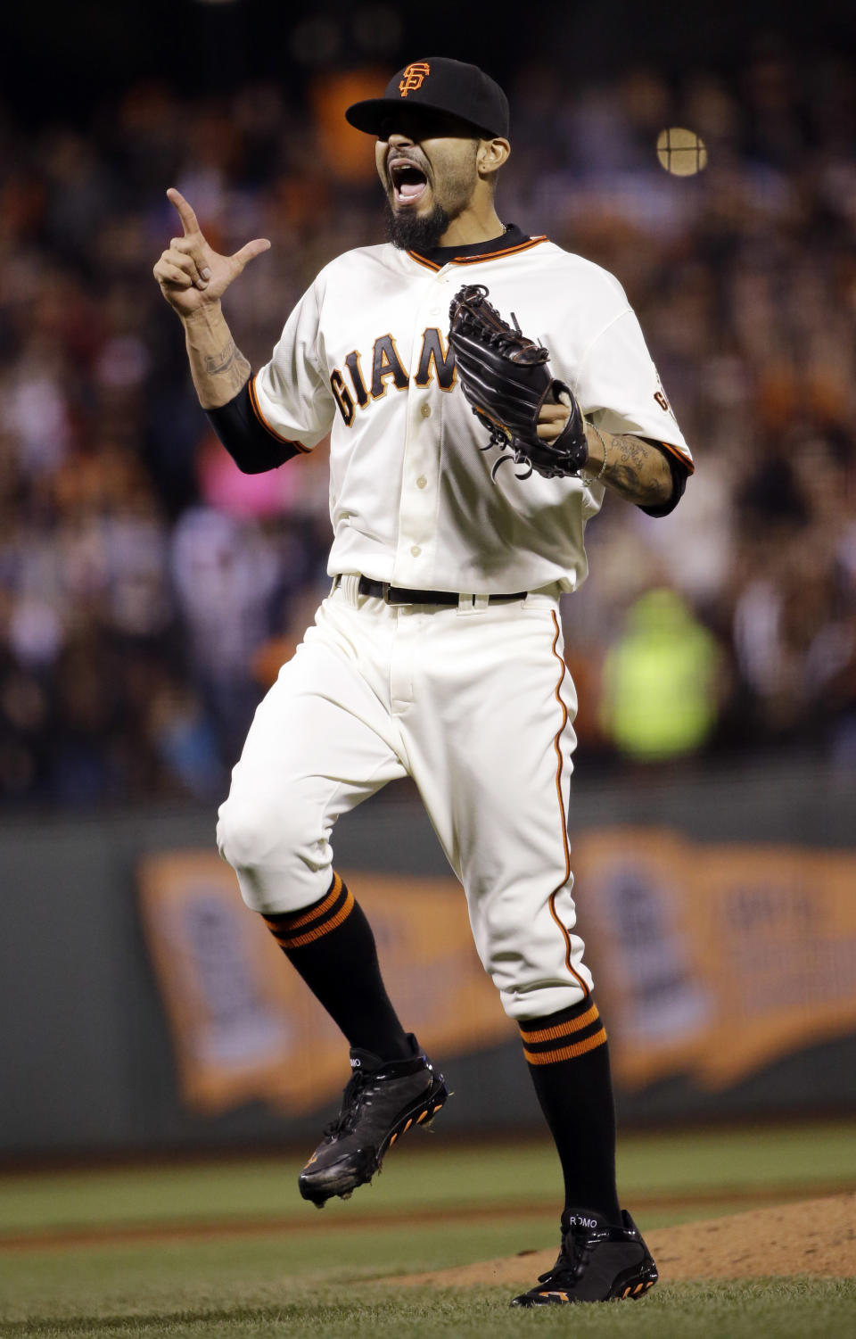 San Francisco Giants reliever Sergio Romo celebrates as he records the last out of the game against the Los Angeles Dodgers during the ninth inning of a baseball game on Wednesday, April 16, 2014, in San Francisco. San Francisco won 2-1. (AP Photo/Marcio Jose Sanchez)