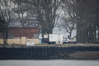 A truck loaded with bodies drives towards a burial trench on Hart Island, Thursday, April 9, 2020, in the Bronx borough of New York. New York City could bury virus victims in temporary graves if city morgues are overwhelmed. Mayor Bill DeBlasio said earlier in the week that officials have explored the possibility of temporary burials on Hart Island, a strip of land in Long Island Sound that has long served as the city’s potter’s field. The city’s 2008 Pandemic Influenza Surge Plan states that Hart Island would be used as a temporary burial site in the event the death toll reaches the tens of thousands and if other storage, such as the refrigerator trucks parked outside hospitals, is full. (AP Photo/John Minchillo)