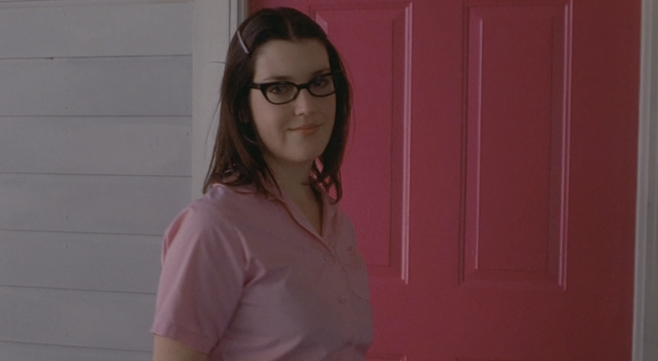 melanie's character wearing glasses and smiling