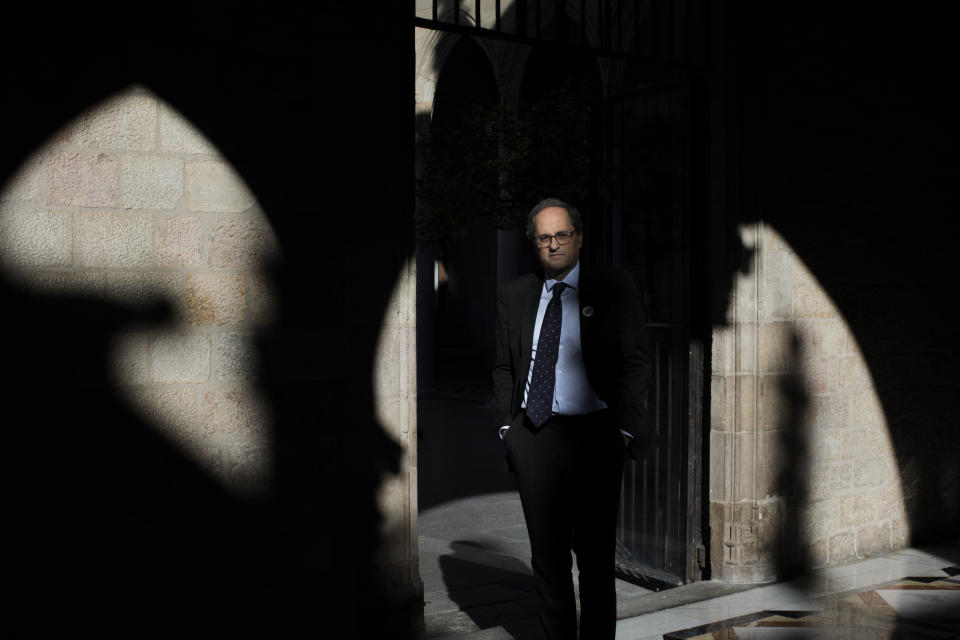 In this Thursday, Jan. 10, 2019 photo, Catalan regional president Quim Torra poses for a photo at the Palace of Generalitat or Catalan government headquarters, ahead of an interview with The Associated Press, in Barcelona, Spain. Catalonia separatist leader says that the Spanish government's bid to pass a national budget is doomed unless the wealthy northeastern region is allowed to hold a referendum on secession from the rest of the country. (AP Photo/Emilio Morenatti)