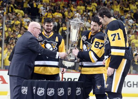 May 25, 2017; Pittsburgh, PA, USA; NHL deputy commissioner Bill Daly (left) presents the Prince of Wales trophy to Pittsburgh Penguins left wing Chris Kunitz (14) and center Sidney Crosby (87) and center Evgeni Malkin (71) as champions of the Eastern Conference after the Pens defeated the Ottawa Senators in double overtime of game seven of the Eastern Conference Final of the 2017 Stanley Cup Playoffs at the PPG PAINTS Arena. Mandatory Credit: Charles LeClaire-USA TODAY Sports