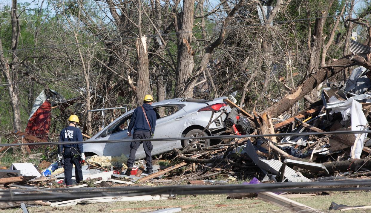 Wichita firefighters search what's left of John's Animal World on Saturday, April 30, 2022 in Kansas. A suspected tornado that barreled through parts of Kansas damaged multiple buildings and injured several people.