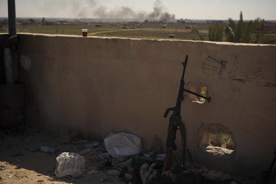 Columns of black smoke billow from the last small piece of territory held by Islamic State militants as U.S. backed fighters pounded the area with artillery fire and occasional airstrikes as seen from a Syrian Democratic Forces rooftop position in Baghouz, Syria, Sunday, March 3, 2019. (AP Photo/Andrea Rosa)