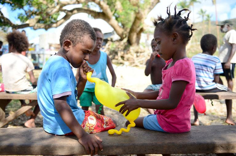 Children play with balloons that were part of a small relief package arranged by an Australian aid donor in the village of Saama, near Vanuatu's capital of Port Vila on March 21, 2015 after Cyclone Pam ripped through the island nation