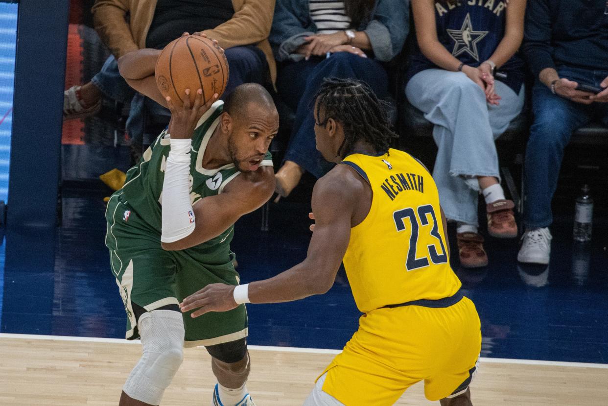 Milwaukee Bucks forward Khris Middleton (22) holds the ball while Indiana Pacers forward Aaron Nesmith (23) defends during game four of the first round for the 2024 NBA playoffs at Gainbridge Fieldhouse.