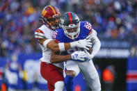 New York Giants' Darius Slayton, right, makes a catch during the first half of an NFL football game against the Washington Commanders, Sunday, Dec. 4, 2022, in East Rutherford, N.J. (AP Photo/John Munson)