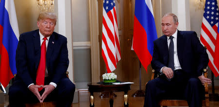 FILE PHOTO: U.S. President Donald Trump meets with Russian President Vladimir Putin in Helsinki, Finland, July 16, 2018. Reuters photographer Kevin Lamarque: "Body language can give an ordinary photo much more meaning, and here, Trump and Putin did not disappoint." REUTERS/Kevin Lamarque/File Photo