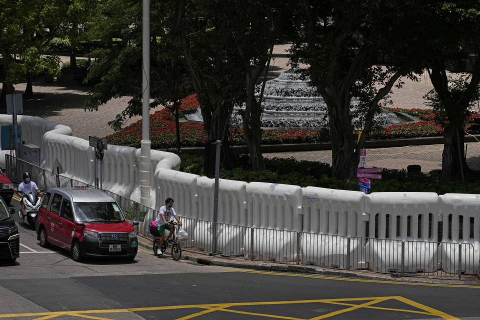 FILE - Water-filled barriers have been installed by police outside the Hong Kong Convention and Exhibition Centre where the inauguration ceremony of the newly-appointed Chief Executive John Lee will take place in Hong Kong, on June 27, 2022. Hong Kong’s police force on Tuesday, June 28, 2022, confirmed that Chinese president Xi Jinping will visit the city for the 25th anniversary of the former British colony’s return to Chinese rule. (AP Photo/Kin Cheung, File)