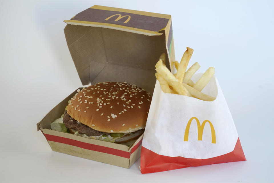 A McDonald's Big Mac, left, rests in a box next to a bag of McDonald's fries, in Walpole, Mass., Wednesday, April 20, 2022. Environmental and health groups are pushing dozens of fast food companies, supermarkets chains and other retail outlets to remove PFAS from their packaging. (AP Photo/Steven Senne)