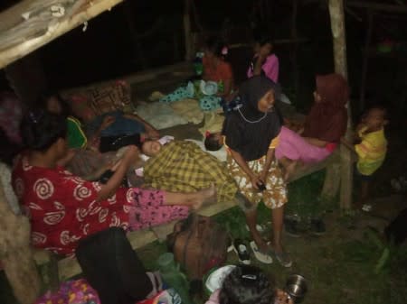 Locals stay outside their house following earthquake hit at Tokaka village in South Halmahera, North Maluku