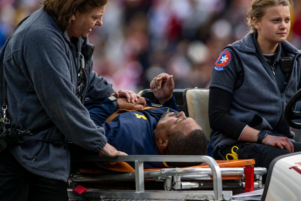 Michigan running game coordinator Mike Hart was carted off the field on a backboard during the first half against Indiana, Saturday, Oct. 8, 2022, in Bloomington, Ind.