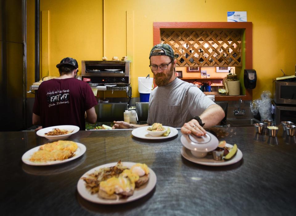 Josh Taylor, a sous chef at The Soup Spoon Cafe plates up food, Monday, Aug. 14, 2023, during the lunch rush.