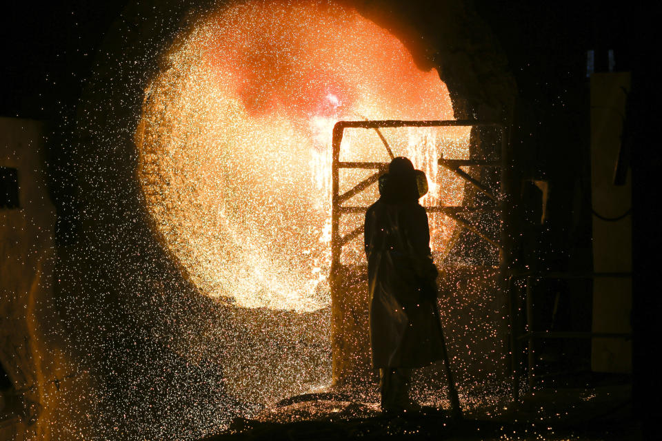 An employee in protective clothing maintains at steel pouring ladle during a guided media tour at the steel producer Salzgitter AG in Salzgitter, March 5, 2019. (Photo: Markus Schreiber/AP)