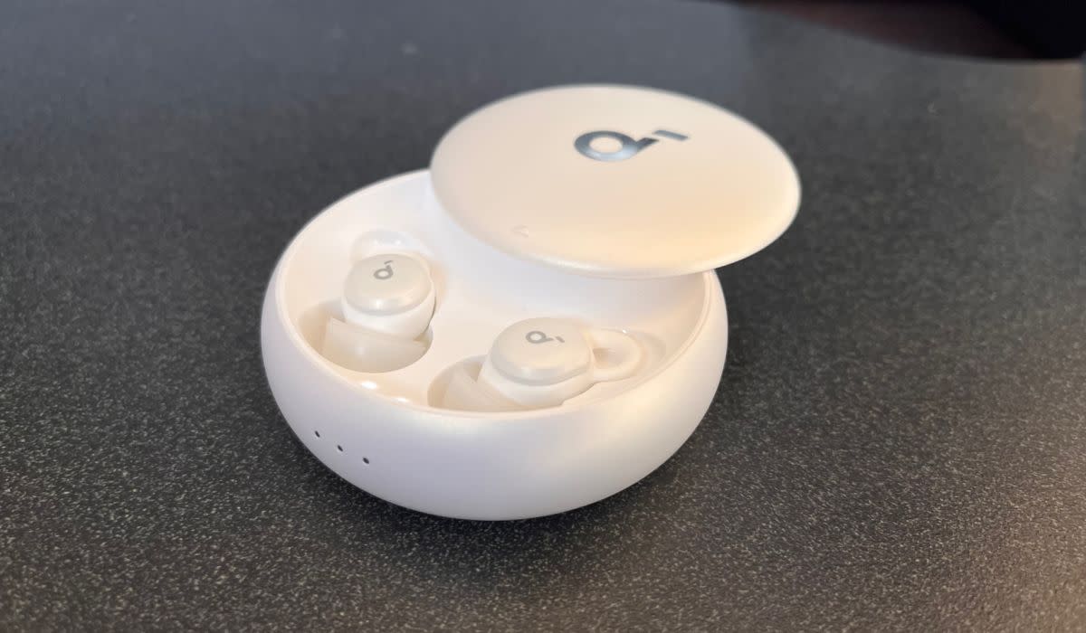 A photo of the Soundcore Sleep A10 earbuds inside the case, with the case door slid open.