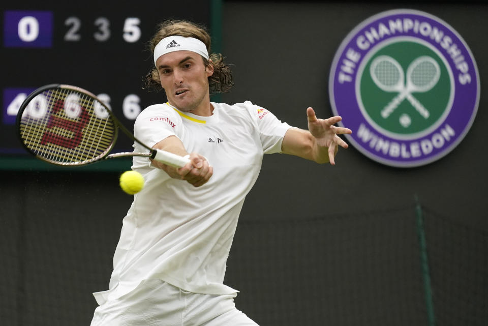 Greece's Stefanos Tsitsipas returns to Australia's Jordan Thompson in a second round men's singles match on day four of the Wimbledon tennis championships in London, Thursday, June 30, 2022. (AP Photo/Alberto Pezzali)