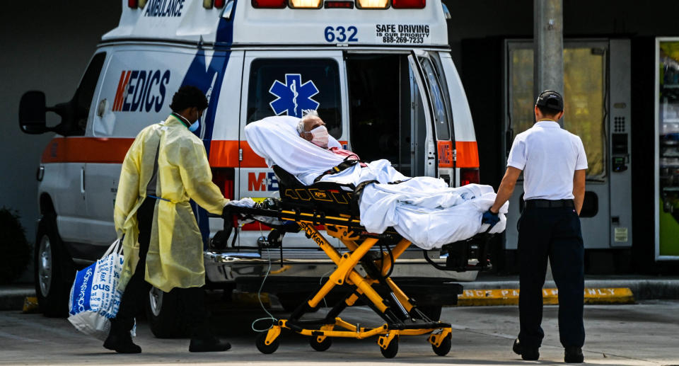 Medics transfer a patient on a stretcher from an ambulance outside of Emergency at Coral Gables Hospital where Coronavirus patients are treated in Coral Gables near Miami, on August 16, 2021. Source: Getty Images