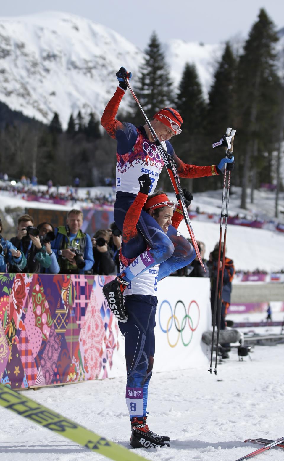 Russia's Alexander Legkov, the gold medal winner, is carried on the shoulders of bronze medalist Russia's Ilia Chernousov after the men's 50K cross-country race at the 2014 Winter Olympics, Sunday, Feb. 23, 2014, in Krasnaya Polyana, Russia. (AP Photo/Gregorio Borgia)