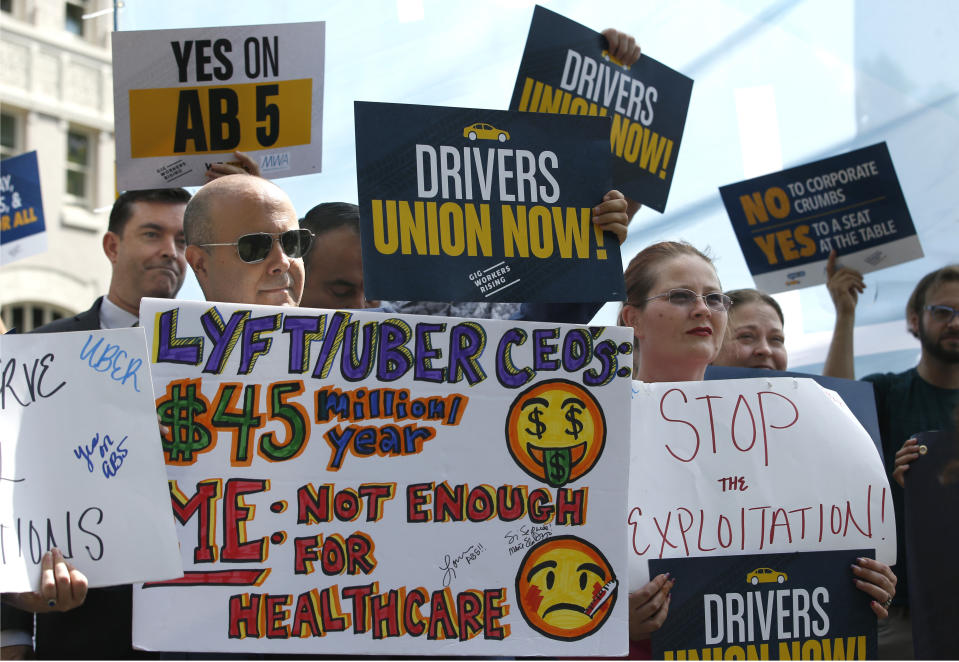 Dozens of supporters of a measure to limit when companies can label workers as independent contractors rally at the Capitol in Sacramento, Calif., Wednesday, Aug. 28, 2019. If approved by the legislature and signed by Gov. Gavin Newsom, AB5, by Assemblywoman Lorena Gonzalez, D-San Diego, would require companies like Uber and Lyft to treat their drivers like employees. (AP Photo/Rich Pedroncelli)