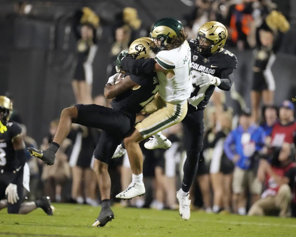 Colorado safety Cam’Ron Silmon-Craig, left, intercepts a pass intended for Colorado State tight end Dallin Holker, center, as Colorado safety Shilo Sanders joins in the coverage Saturday, Sept. 16, 2023, in Boulder, Colo. The former BYU player didn’t snag this ball but caught six others and scored two touchdowns. | David Zalubowski, Associated Press