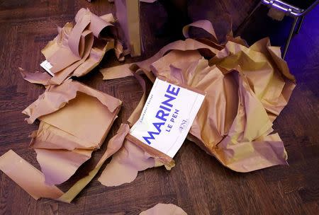 An assistant prepares placards with the name of France's National Front leader Marine Le Pen before the start of a European far-right leaders meeting to discuss about the European Union, in Koblenz, Germany, January 21, 2017. REUTERS/Wolfgang Rattay