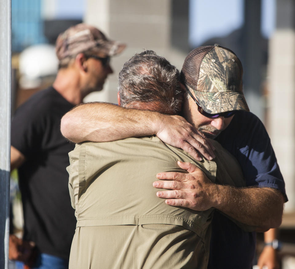 Scott Daspit, the father of missing crew member Dylan Daspit, receives a long hug of support as the search continues for 7 missing Seacor Power crew members, at Harbor Light Marina in Cocodrie, La., Thursday, April 29, 2021. The United Cajun Navy and other volunteers joined forces to locate 7 missing Seacor Power crew members 16 days after the lift boat capsized about 8 miles from Port Fourchon during bad weather. (Sophia Germer/The Advocate via AP)