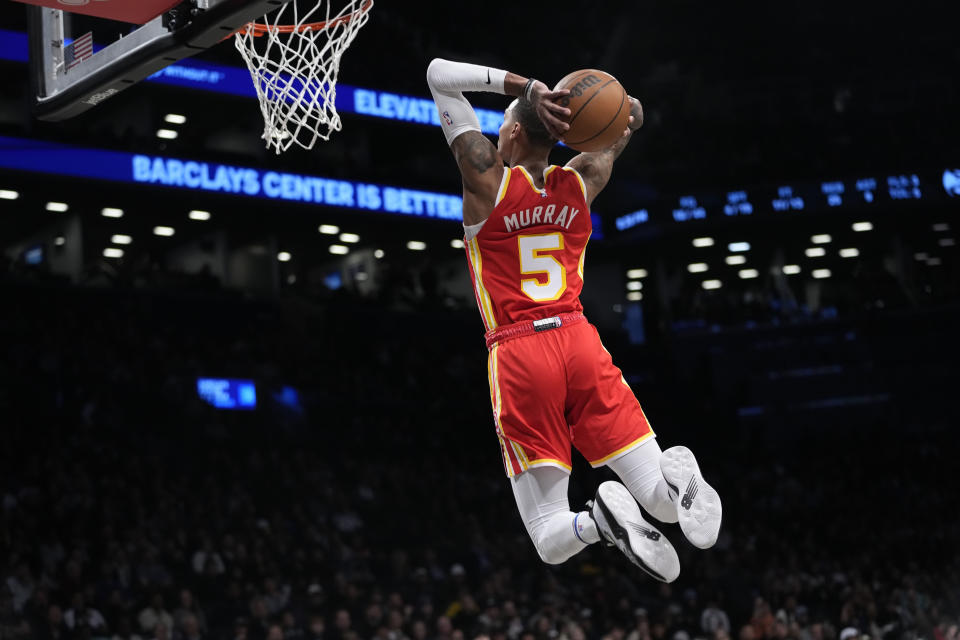 Atlanta Hawks guard Dejounte Murray goes up for a dunk during the first half of the team's NBA basketball game against the Brooklyn Nets, Friday, March 31, 2023, in New York. (AP Photo/Mary Altaffer)