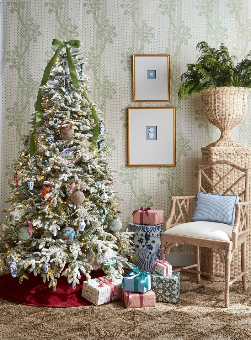 <p>A <a href="https://www.countryliving.com/diy-crafts/a28702734/how-to-flock-christmas-tree/" rel="nofollow noopener" target="_blank" data-ylk="slk:flocked Christmas tree;elm:context_link;itc:0;sec:content-canvas" class="link ">flocked Christmas tree</a> gets dressed up with vintage glass bead garlands, cross-stitched ornaments, and velvet bows both as a topper and on pastel-wrapped presents. </p>