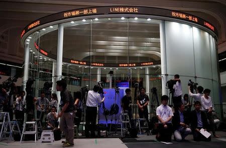 Members of the media wait for Line Corp's bell ceremony to mark the company's debut on the Tokyo Stock Exchange in Tokyo, Japan July 15, 2016. REUTERS/Issei Kato