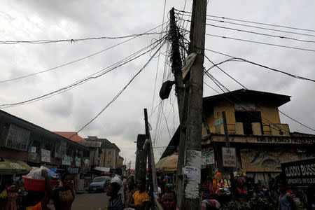 FILE PHOTO: Electric cables are seen on a pole across a road in Ojodu district in Nigeria's commercial capital Lagos, August 8, 2017. Picture taken August 8, 2017. REUTERS/Akintunde Akinleye/File Photo