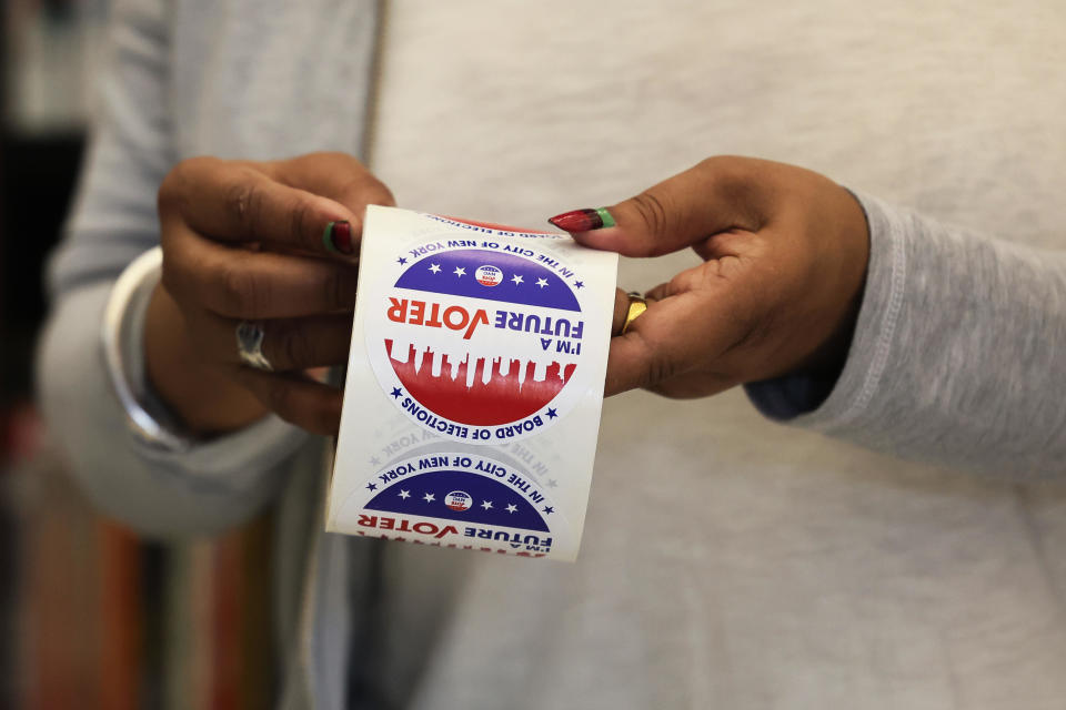 FILE: NEW YORK, NEW YORK - JUNE 28: A poll worker peels voting stickers during the June Primary Election at Brooklyn Central Library on June 28, 2022 in New York, New York.  / Credit: Michael M Santiago/GettyImages / Getty Images