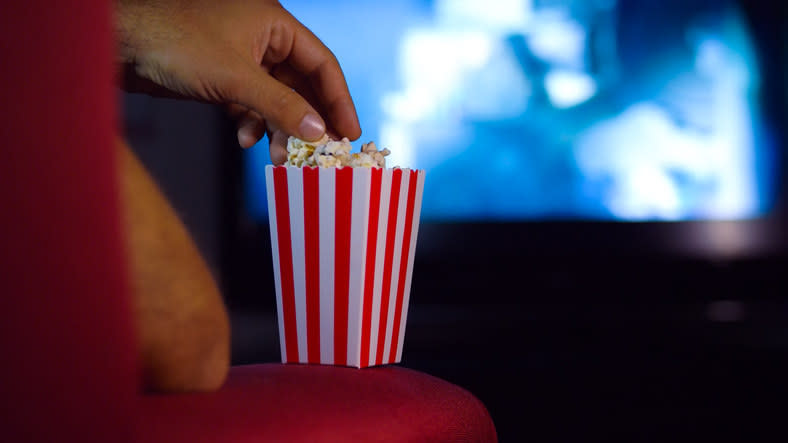 Someone eating popcorn at the movies