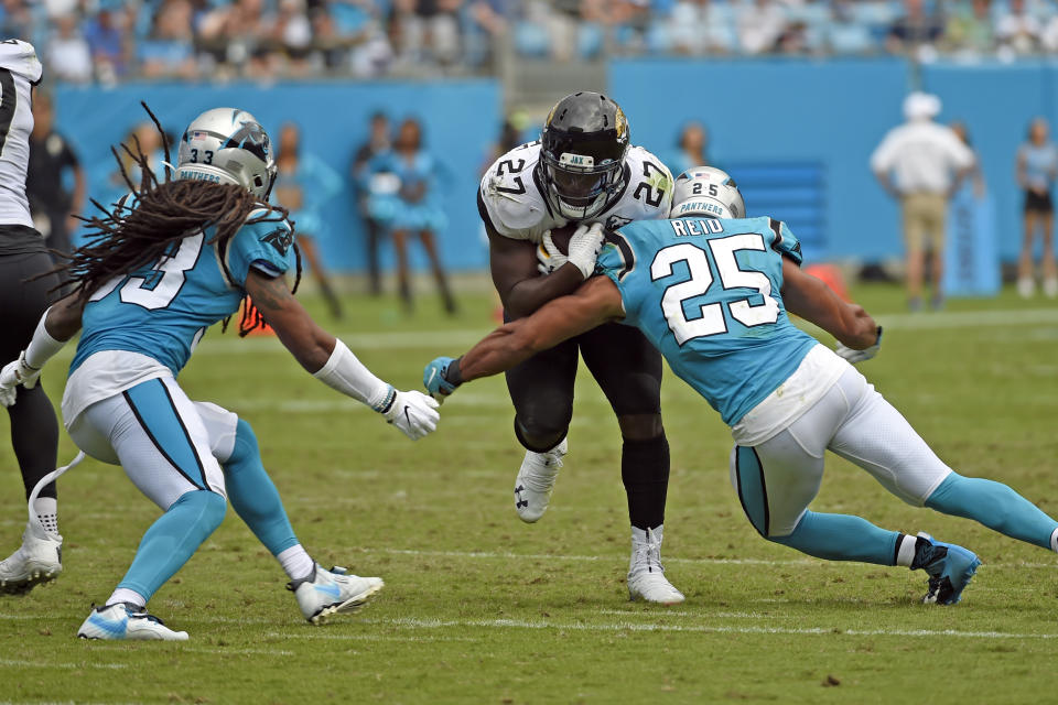 Carolina Panthers strong safety Eric Reid (25) and defensive back Tre Boston (33) look to tackle Jacksonville Jaguars running back Leonard Fournette (27) during the second half of an NFL football game in Charlotte, N.C., Sunday, Oct. 6, 2019. (AP Photo/Mike McCarn)