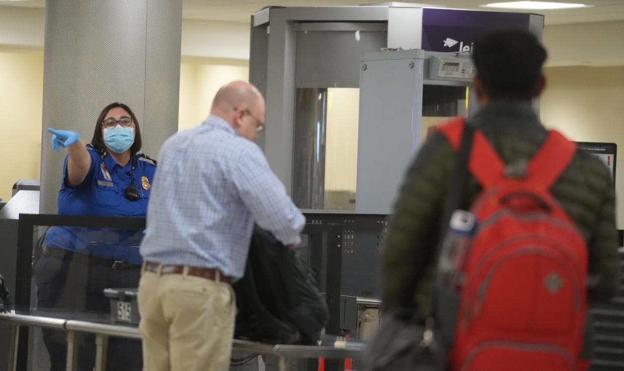 Travelers pass through a Transportation Security Administration checkpoint on Tuesday, Jan. 9, 2024, at John Glenn Columbus International Airport.