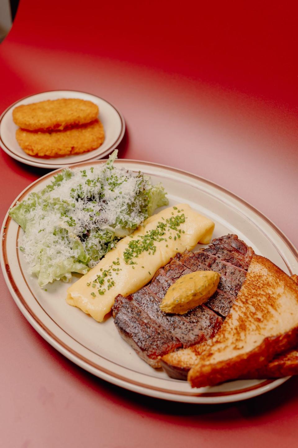 Steak and Eggs at Kinfolk, a diner in Downtown Memphis. A 6-ounce Home Place Pastures NY Strip is served with two eggs, cowboy butter, hash browns or grits, dressed side salad, a buttermilk honey butter biscuit or milk bread toast.