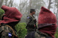 Soldiers guard the area where Hilda Hernandez, the sister of Honduran President Juan Orlando Hernandez, and five others died when the helicopter they were traveling in crashed in San Matias, Honduras, December 17, 2017. REUTERS/ Jorge Cabrera