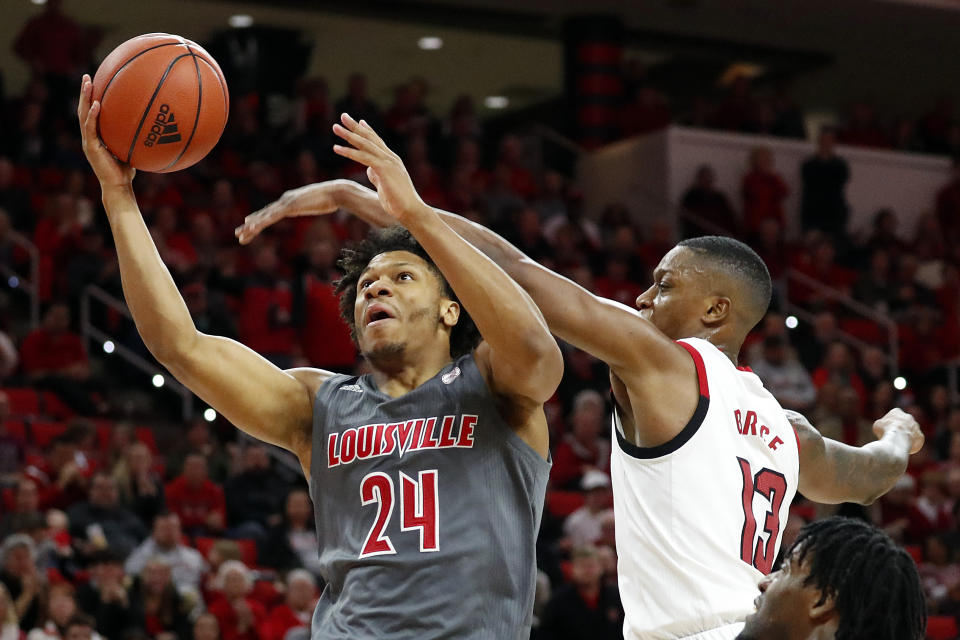 Louisville's Dwayne Sutton (24) drives the ball to the basket past North Carolina State's C.J. Bryce (13) during the second half of an NCAA college basketball game in Raleigh, N.C., Saturday, Feb. 1, 2020. (AP Photo/Karl B DeBlaker)