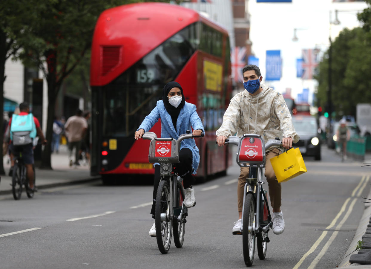 Shoppers cycle on Santander bikes on Oxford Street, London, as non-essential shops in England open their doors to customers for the first time since coronavirus lockdown restrictions were imposed in March. Picture date: Monday June 15, 2020.