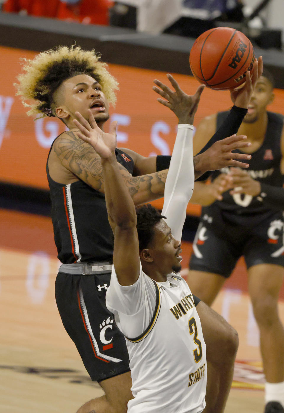 Cincinnati guard Mike Saunders (3) goes up for a shot as Wichita State guard Alterique Gilbert (3) defends during the first half of an NCAA college basketball game in the semifinal round of the American Athletic Conference men's tournament Saturday, March 13, 2021, in Fort Worth, Texas. (AP Photo/Ron Jenkins)