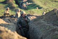 Armenian soldiers take their position on the front line in Tavush region, Armenia, Tuesday, July 14, 2020. Skirmishes on the volatile Armenia-Azerbaijan border escalated Tuesday, marking the most serious outbreak of hostilities between the neighbors since the fighting in 2016. (Armenian Defense Ministry Press Service/PanPhoto via AP)