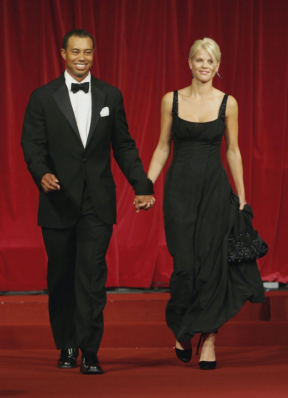 Tiger Woods and his wife Elin walk down the catwalk during the Ryder Cup Gala Dinner at Citywest Hotel and Golf Resort September 20, 2006 in Dublin, Ireland. (Photo by David Cannon/Getty Images)