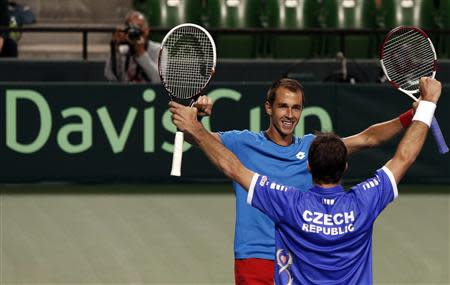 Lukas Rosol (facing camera) and Radek Stepanek of the Czech Republic celebrate after winning their Davis Cup men's doubles quarter-final tennis match against Japan's Tatsuma Ito and Yasutaka Uchiyama in Tokyo April 5, 2014. This win ensures the Czech team advances to the Davis Cup semi-finals. REUTERS/Yuya Shino