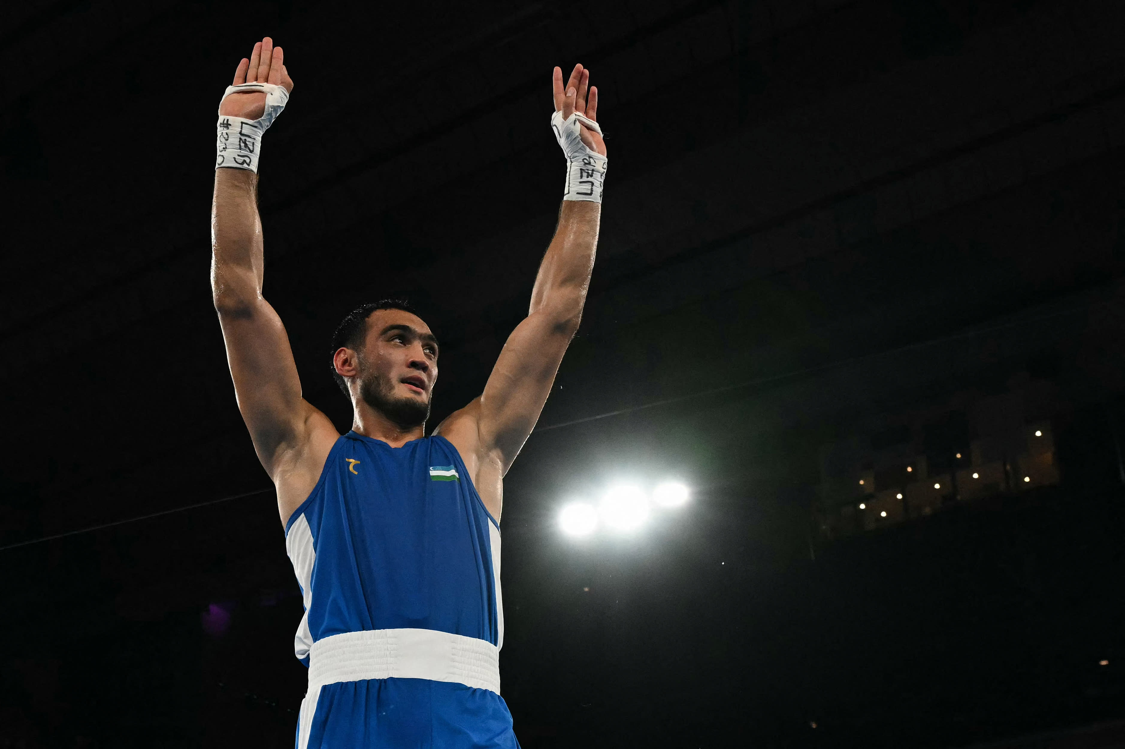 Uzbekistan's Lazizbek Mullojonov (blue) reacts after defeating Azerbaijan's Loren Berto Alfonso Dominguez in the men's -92kg boxing final during the Paris 2024 Olympic Games at Roland Garros Stadium on August 9, 2024. (Mohd Rasfan/AFP/Getty Images)